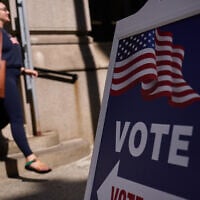 A sign directs voters to an entrance for City Hall during early voting for the Rhode Island primary election, September 2, 2026, in Providence, Rhode Island. (AP Photo/David Goldman)