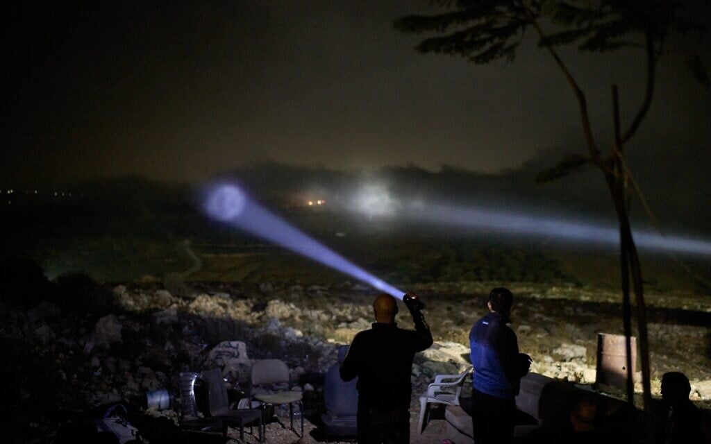A Palestinian scans a valley with a flashlight as cars move on the top of a hill during a volunteer night watch to help prevent Israeli settler attacks in the West Bank town of Sinjil, September 2, 2026. (AP/Leo Correa) A Palestinian scans a valley with a flashlight as cars move on the top of a hill during a volunteer night watch to help prevent Israeli settler attacks in the West Bank town of Sinjil, September 2, 2026. (AP/Leo Correa)