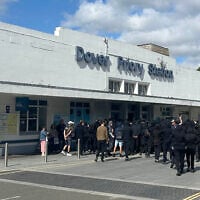 Protesters gather at Dover Priory train station after black-clad and masked demonstrators blocked roads during a protest, in Dover, England, September 5, 2026. (Oscar Rihll/PA via AP)