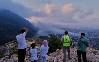 People watch a smoke rise from an Israeli airstrike that hit a house in Arab Salim village, southern Lebanon, September 6, 2026. People watch a smoke rise from an Israeli airstrike that hit a house in Arab Salim village, southern Lebanon, September 6, 2026.
