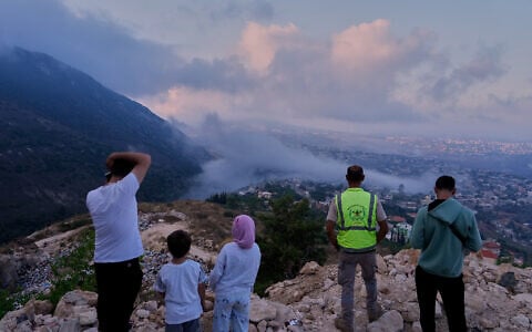 People watch a smoke rise from an Israeli airstrike that hit a house in Arab Salim village, southern Lebanon, September 6, 2026.