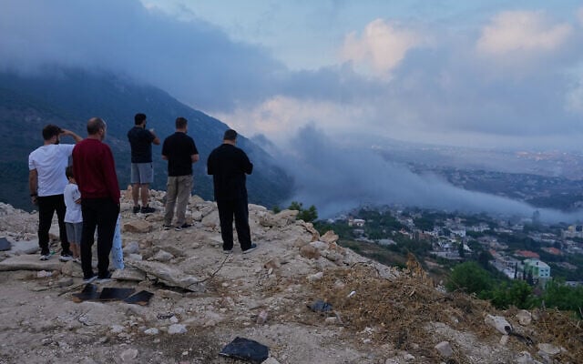 People watch a smoke rise from an Israeli airstrike that hit a house in Arab Salim village after an evacuation warning, southern Lebanon, September 6, 2026. (AP Photo/Mohammed Zaatari)