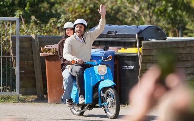 Ulrich Siegmund, top candidate for the 'Alternative for Germany' (AfD) party arrives with his wife Julia on a small Schwalbe motorcycle for his voting at a polling station during the Saxony-Anhalt state elections in Tangermuende, eastern Germany, September 6, 2026. (AP Photo/Matthias Schrader)
