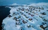 Houses covered in snow are seen on the coast of a sea inlet of Nuuk, Greenland, March 7, 2025. (AP Photo/Evgeniy Maloletka)