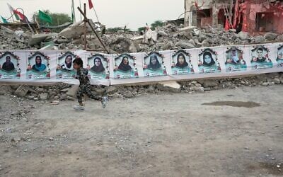 A child runs past a banner strung across the rubble of the Shajareh Tayyebeh school showing portraits of the children and teachers killed there by a February 28 US airstrike in Minab, southern Iran, September 7, 2026. (AP/Vahid Salemi) A child runs past a banner strung across the rubble of the Shajareh Tayyebeh school showing portraits of the children and teachers killed there by a February 28 US airstrike in Minab, southern Iran, September 7, 2026. (AP/Vahid Salemi)