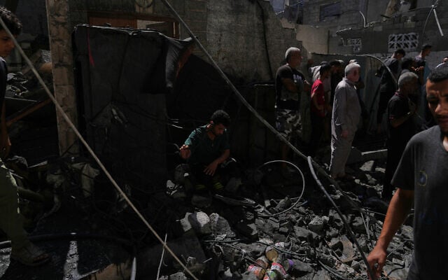 Palestinians inspect a building destroyed in an Israeli airstrike in Gaza City, September 9, 2026. (AP Photo/Jehad Alshrafi)