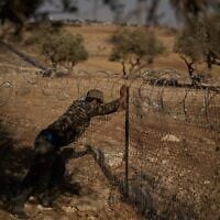 A man works on a fence at a Palestinian-Bedouin family’s house to try to prevent attacks from Israeli settlers on the outskirts of the West Bank town of Taybeh, September 9, 2026. (AP Photo/Leo Correa)