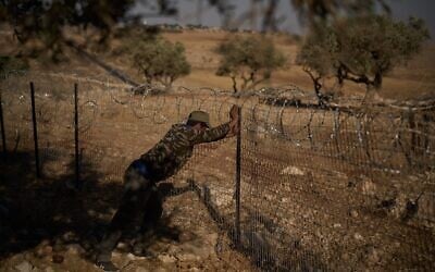 A man works on a fence at a Palestinian-Bedouin family’s house to try to prevent attacks from Israeli settlers on the outskirts of the West Bank town of Taybeh, September 9, 2026. (AP Photo/Leo Correa)