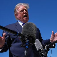 US President Donald Trump talks with reporters after an emergency inflatable slide deployed on Air Force One before before Trump arrived to board at Joint Base Andrews, Maryland, September 9, 2026. (AP/Jacquelyn Martin)