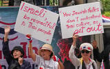 Protesters hold signs, including one on the left that calls on Jews to 'get out,' at a rally in front of Israeli embassy in Bangkok, Thailand, September 10, 2026. (AP Photo/Sakchai Lalit)