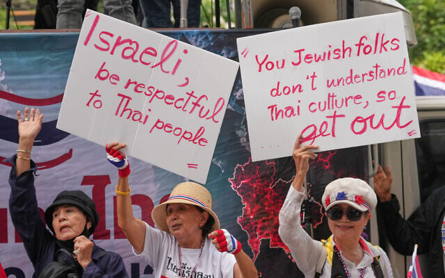 Protesters holding signs attend a demonstration demanding an end to alleged land-grabbing by foreigners, in front of Israeli Embassy in Bangkok, Thailand, September 10, 2026. (AP Photo/Sakchai Lalit)