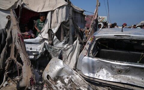 Palestinians gather at the site of an Israeli military strike that, according to health authorities, killed at least one person in Khan Younis, southern Gaza Strip, September 11, 2026. (AP Photo/Jehad Alshrafi)