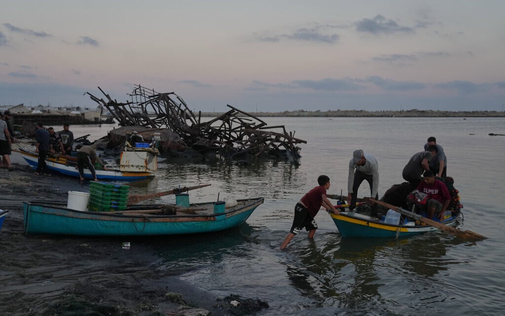 Palestinian fishermen depart in their boat on Mediterranean Sea from the damaged seaport in Gaza City, September 13, 2026. (AP Photo/Jehad Alshrafi)