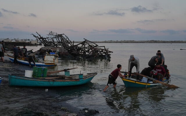 Palestinian fishermen depart in their boat on Mediterranean Sea from the damaged seaport in Gaza City, September 13, 2026. (AP Photo/Jehad Alshrafi)