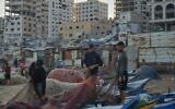 Palestinian fishermen work on their fishing nets in the morning at the damaged port of Gaza City, September 13, 2026. (AP Photo/Jehad Alshrafi)