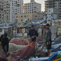 Palestinian fishermen work on their fishing nets in the morning at the damaged port of Gaza City, September 13, 2026. (AP Photo/Jehad Alshrafi)