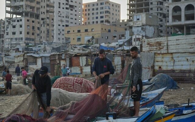 Palestinian fishermen work on their fishing nets in the morning at the damaged port of Gaza City, September 13, 2026. (AP Photo/Jehad Alshrafi)