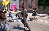People run from the police during a march in support of transgender people during the LGBTQ Pride week, in Istanbul, Turkey, on June 21, 2026. (AP Photo/Dilara Acikgoz)