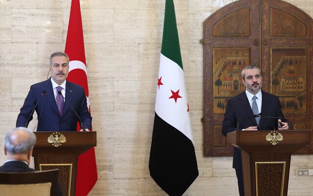 Turkish Foreign Minister Hakan Fidan, left, and his Syrian counterpart Asaad al-Shibani address the media during a joint news conference in Damascus, Syria, September 13, 2026. (AP Photo/Ghaith Alsayed)