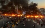 Protesters burn tires and other debris to block a highway as demonstrations over fuel price increases spread across Syria, in Maarat al-Numan, Idlib province, September 13, 2026. (AP Photo/Ahmed Albam)