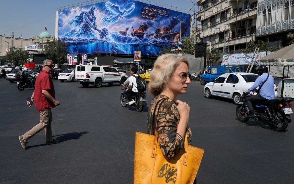 Pedestrians walk past a billboard depicting a Persian legendary hero and flying figure hitting US aircraft carriers alongside the message in English and Farsi: 'From the Persian Gulf a new power rises' and 'The army of Satan will be drowned in the Persian Gulf,' at Islamic Revolution square in downtown Tehran, Iran, September 14, 2026. (AP Photo/Vahid Salemi) Pedestrians walk past a billboard depicting a Persian legendary hero and flying figure hitting US aircraft carriers alongside the message in English and Farsi: 'From the Persian Gulf a new power rises' and 'The army of Satan will be drowned in the Persian Gulf,' at Islamic Revolution square in downtown Tehran, Iran, September 14, 2026. (AP Photo/Vahid Salemi)