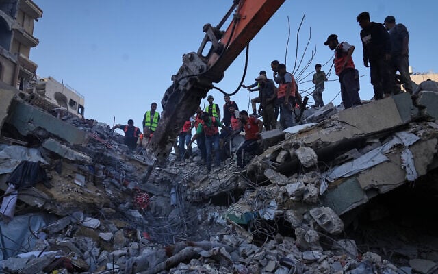 Palestinian crews search for bodies and survivors in the rubble of a collapsed building that housed displaced Palestinians and was heavily damaged during the Israel-Hamas war, in Gaza City, September 16, 2026. (AP Photo/Jehad Alshrafi)