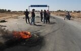 Local residents block a road to prevent oil tankers from the Rmeilan oil fields from passing during ongoing protests against higher fuel prices at the entrance to Tal Tamr, northeastern Syria, September 16, 2026. (AP Photo/Baderkhan Ahmad)