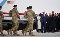 An Army carry team moves a flag-draped transfer case with the remains of Sgt. Declan Coady, 20, of West Des Moines, Iowa, past US President Donald Trump and first lady Melania Trump during a casualty return, March 7, 2026, at Dover Air Force Base, Delaware. (AP Photo/Mark Schiefelbein)