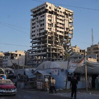 Tents sheltering displaced Palestinians and a market surround a heavily damaged building in Gaza City, September 17, 2026. (AP/Jehad Alshrafi)