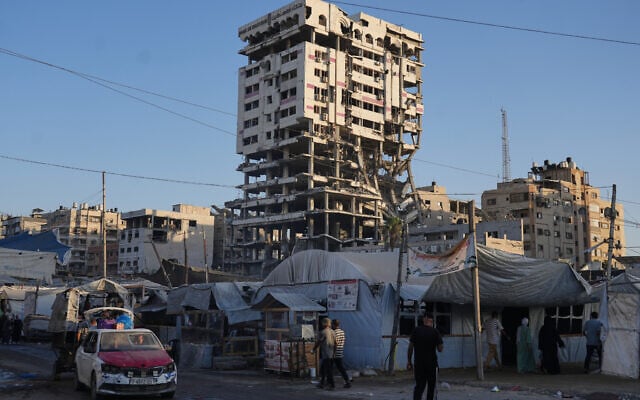 Tents sheltering displaced Palestinians and a market surround a building heavily damaged during the Israel-Hamas war in Gaza City, September 17, 2026. (AP/Jehad Alshrafi)