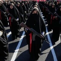 Women affiliated with Iran’s Revolutionary Guards carry rifles as they stand during the state-organized 'Janfada,' or 'Sacrifice for Iran,' military-style parade in Tehran, Iran, September 18, 2026. (AP Photo/Vahid Salemi)