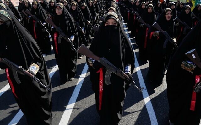 Women affiliated with Iran’s Revolutionary Guards carry rifles as they stand during the state-organized 'Janfada,' or 'Sacrifice for Iran,' military-style parade in Tehran, Iran, September 18, 2026. (AP Photo/Vahid Salemi)