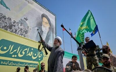 An armed Shiite cleric rides aboard a military vehicle past a billboard depicting Ayatollah Ruhollah Khomeini, founder of the Islamic Republic, during the state-organized “Janfada,” or “Sacrifice for Iran,” military-style parade in Tehran, Iran, September 18, 2026. (AP Photo/Vahid Salemi) An armed Shiite cleric rides aboard a military vehicle past a billboard depicting Ayatollah Ruhollah Khomeini, founder of the Islamic Republic, during the state-organized “Janfada,” or “Sacrifice for Iran,” military-style parade in Tehran, Iran, September 18, 2026. (AP Photo/Vahid Salemi)