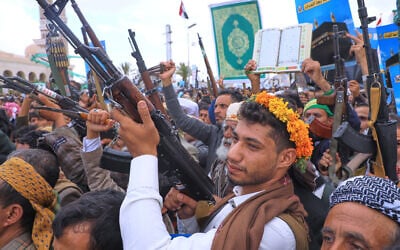 Supporters of Yemen’s Houthi rebels raise their machine guns during a rally in support of the group and to protest Saudi Arabia’s accusation that the Houthis targeted Islam’s holiest site of Mecca, in Sanaa, Yemen, September 18, 2026. (AP/Osamah Abdulrahman)