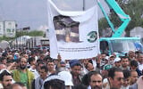 Supporters of Yemen’s Houthi rebels raise a banner during a rally in support of the group and to protest Saudi Arabia’s accusation that the Houthis targeted Islam’s holiest site of Mecca, in Sanaa, Yemen, September 18, 2026. (AP/Osamah Abdulrahman)