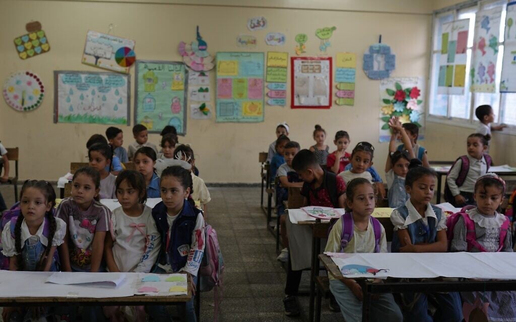Palestinian children sit in their classroom on the first day of the new academic year at a UN-run school in Nuseirat, central Gaza Strip, September 19, 2026. (AP Photo/Jehad Alshrafi)