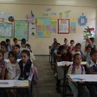 Palestinian children sit in their classroom on the first day of the new academic year at a UN-run school in Nuseirat, central Gaza Strip, September 19, 2026. (AP Photo/Jehad Alshrafi)