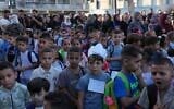 Palestinian children line up on the first day of the new academic year at an UN-run school in Nuseirat, central Gaza Strip, September 19, 2026. (AP Photo/Jehad Alshrafi)