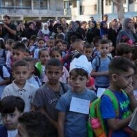 Palestinian children line up on the first day of the new academic year at an UN-run school in Nuseirat, central Gaza Strip, September 19, 2026. (AP Photo/Jehad Alshrafi)