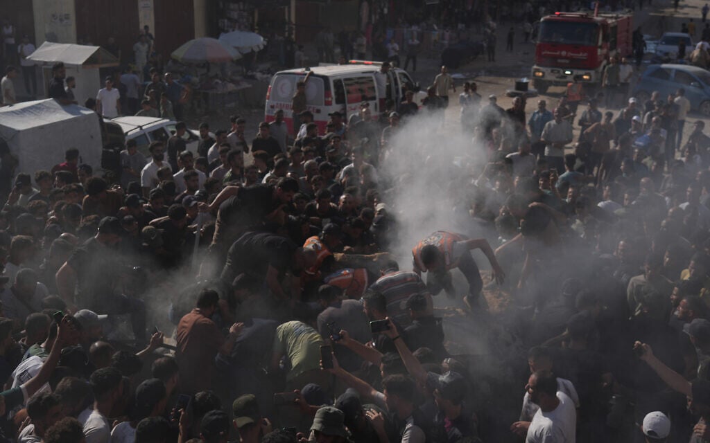 Palestinian rescue workers operate on a destroyed vehicle following an Israeli airstrike in Gaza city, September 19, 2026. (AP Photo/Jehad Alshrafi)