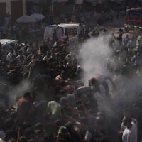 Palestinian rescue workers operate on a destroyed vehicle following an Israeli airstrike in Gaza city, September 19, 2026. (AP Photo/Jehad Alshrafi)