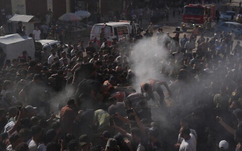 Palestinian rescue workers operate on a destroyed vehicle following an Israeli airstrike in Gaza city, September 19, 2026. (AP Photo/Jehad Alshrafi)