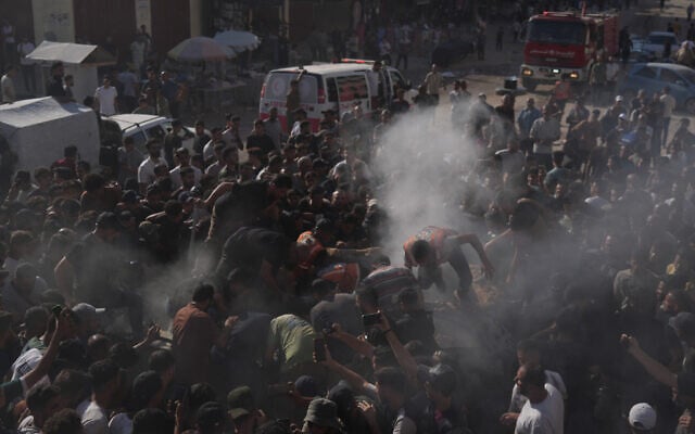 Palestinian rescue workers operate on a destroyed vehicle following an Israeli airstrike in Gaza city, September 19, 2026. (AP Photo/Jehad Alshrafi)