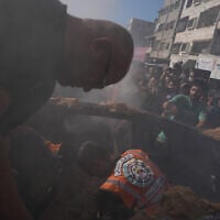 Hamas-run civil defense workers operate on a destroyed vehicle following an Israeli airstrike in Gaza city, September 19, 2026. (AP Photo/Jehad Alshrafi)