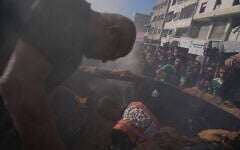 Hamas-run civil defense workers operate on a destroyed vehicle following an Israeli airstrike in Gaza city, September 19, 2026. (AP Photo/Jehad Alshrafi)