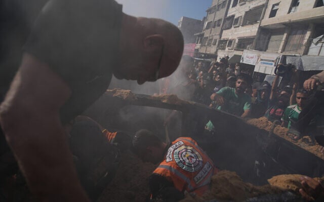 Hamas-run civil defense workers operate on a destroyed vehicle following an Israeli airstrike in Gaza city, September 19, 2026. (AP Photo/Jehad Alshrafi)