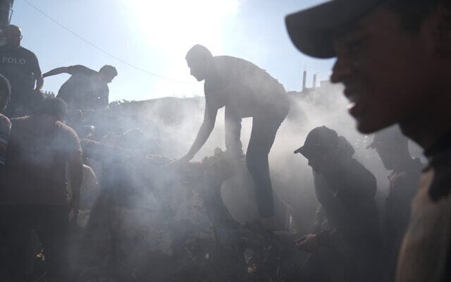 People react near the wreckage of a vehicle destroyed in an Israeli airstrike in Gaza City, September 19, 2026. (AP Photo/Jehad Alshrafi)