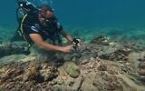 Manager of the Lebanon Diving Center, Youssef Jundi, takes video of pieces of ancient pottery at an archaeological site near the coast in the southern port city of Tyre, Lebanon, September 17, 2026. (Bilal Hussein/AP)