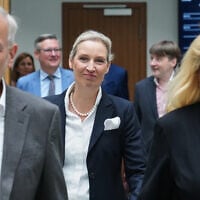 AfD party leader Alice Weidel, center, walks behind top candidates Leif-Erik Holm and Kristin Brinker before a press conference of the “Alternative for Germany” (AfD) in Berlin, Germany, after the previous day's two state elections in Berlin and Mecklenburg-Western Pomerania, September 21, 2026. (AP Photo/Ebrahim Noroozi)