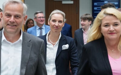 AfD party leader Alice Weidel, center, walks behind top candidates Leif-Erik Holm and Kristin Brinker before a press conference of the “Alternative for Germany” (AfD) in Berlin, Germany, after the previous day's two state elections in Berlin and Mecklenburg-Western Pomerania, September 21, 2026. (AP Photo/Ebrahim Noroozi)